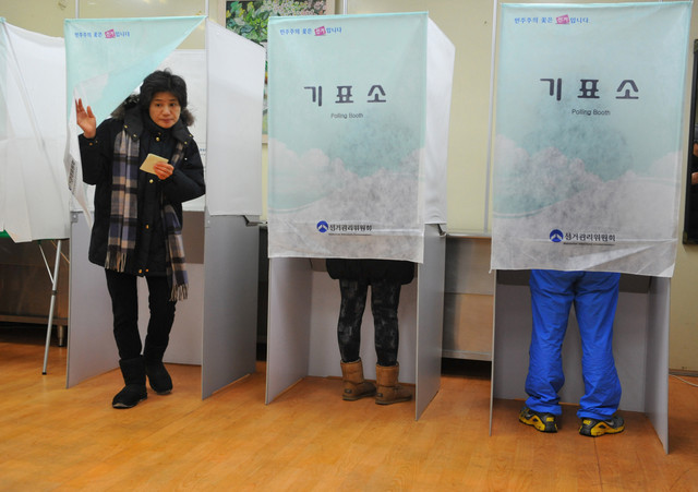 A South Korean woman leaves a polling booth to cast her vote in the country`s presidential elections in Seoul, South Korea. (AFP)