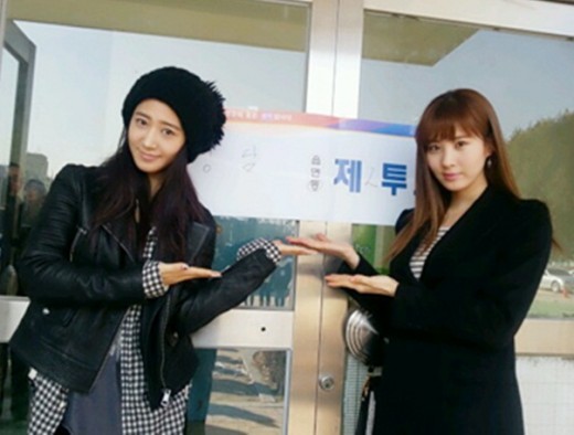 Singer Yuri and Seohyun, members of Korean idol group Girl`s Generation, pose in front of a polling station in Seoul. (SM Entertainment)