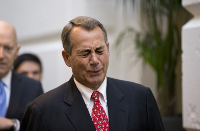 Speaker of the House John Boehner, R-Ohio, winces while talking to a reporter on the way to a closed-door meeting with House Republicans as he negotiates with President Obama to avert the fiscal cliff, at the Capitol in Washington on Tuesday. 9AP-Yonhap News)