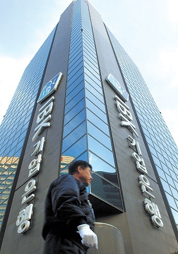 A pedestrian walks past the IBK headquarters in Seoul. (Bloomberg)