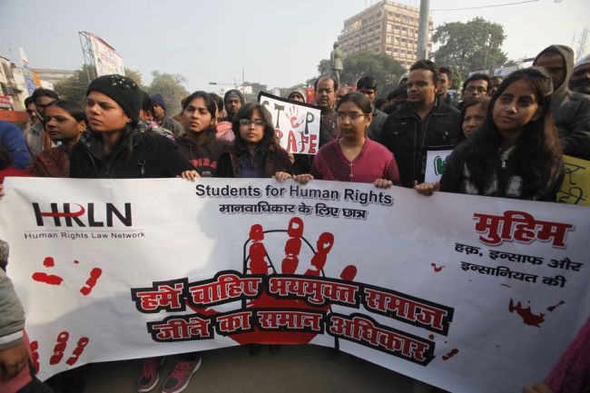 Indian students protesting against the brutal gang-rape of a woman on a bus last week in New Delhi, hold a banner and placards during a protest in Allahabad, India, Wednesday, Dec. 26, 2012. The banner reads, 