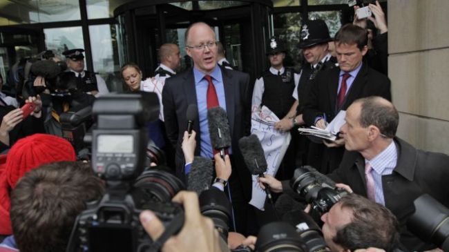 Oct. 23. 2012: George Entwistle, center, the British Broadcasting Corporation (BBC) Director General, talks to members of the media, as he departs Portcullis house in central London. (AP)