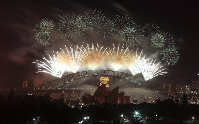 Fireworks explode in the sky above Sydney Harbor during the New Year celebrations in Sydney, Australia, Tuesday. (AP-Yonhap News)