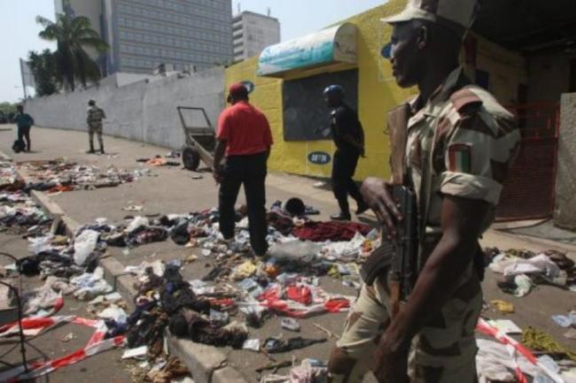 A soldier stands guard at the scene of a stampede in Abidjan, on January 1, 2013. By Herve Sevi (AFP)