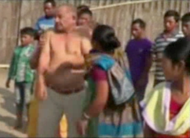 In this image taken from video obtained from Network 1 News and Information Syndicate (NNIS), which has been authenticated based on its contents and other AP reporting, Bikram Singh Brahma, center, a leader of India`s ruling Congress party, is slapped by a woman in the village of Santipur, India, on Thursday. (AP-Yonhap News)