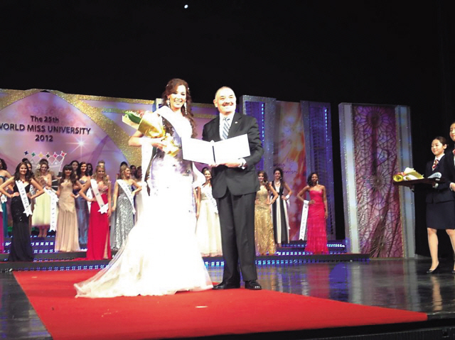 Paraguayan Ambassador Ceferino Valdez poses for a photo with World Miss University beauty contestant Norma Nathalia Chaves Solis during the pageant at Sheraton Grande Walkerhill Hotel, Seoul on Dec. 11.