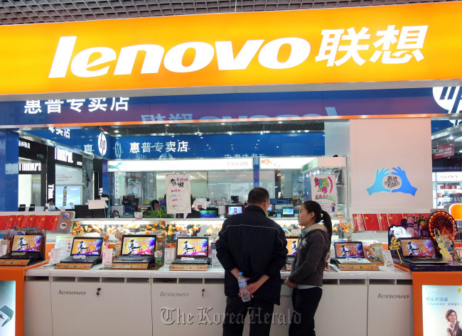 A customer looks at Lenovo Group Ltd. computers at a store in Beijing. (Bloomberg)