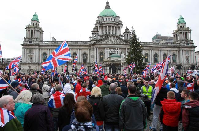 Loyalists march outside Belfast City Hall on Saturday in protest over Belfast city council’s decision to restrict the number of days the British Union Flag can be flown over the city hall. (AFP-Yonhap News)