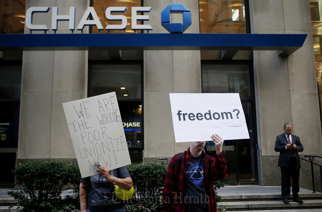 Occupy Wall Street protesters stand outside of a JPMorgan Chase & Co. bank branch during a demonstration in New York. (Bloomberg)