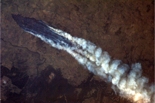 This photo, taken by astronaut Chris Hadfield from the International Space Station, shows a view of the wildfires in Australia. (AP-Yonhap News)