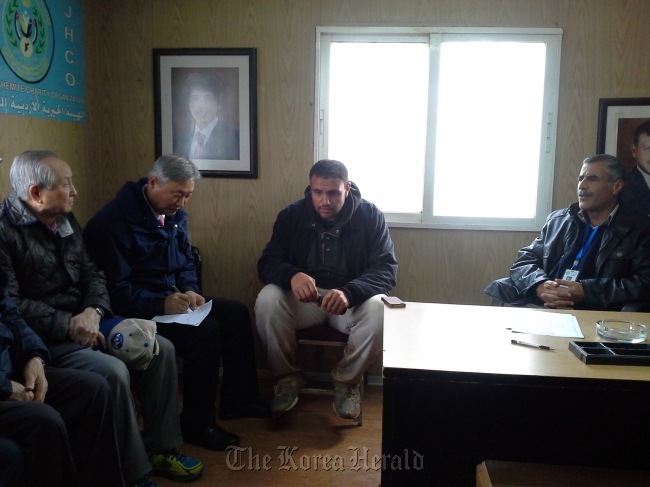 Pastor Kim Jang-hwan (far left) meets with workers at the Zaatari refugee camp in Jordan. (Far East Broadcasting Corporation)