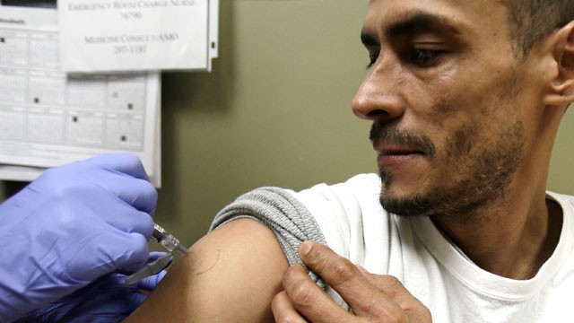 Walter Vazquez, 43, getting a flu shot at MetroHealth in Cleveland. (AP)