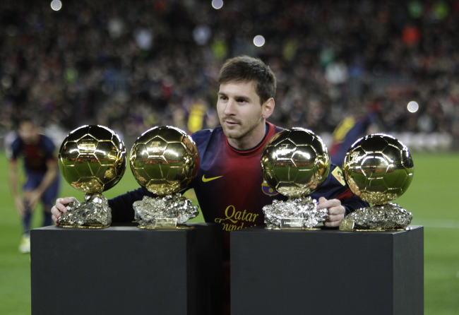 Barcelona’s Lionel Messi poses next to his four FIFA World Player of the Year awards in Barcelona, Spain, Wednesday. (AP-Yonhap News)