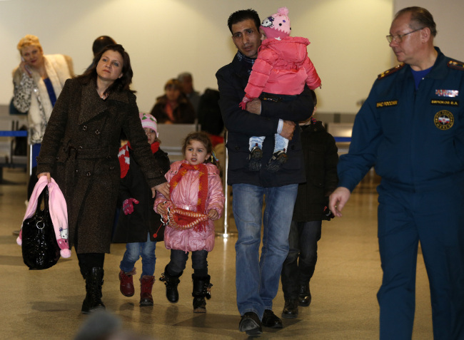 A Russian-Syrian family leaves a passport control zone just after their arrival from Beirut in Moscow Domodedovo airport in Russia on Wednesday. (AP-Yonhap News)