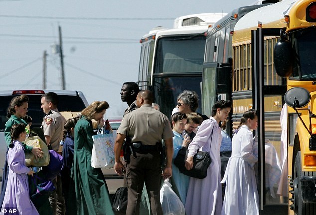 Members of the sect are escorted onto a bus in Eldorado, Texas after a raid on a compound for the Fundamentalist Church Of Jesus Christ Of Latter Day Saints in this undated file photo. (AP)