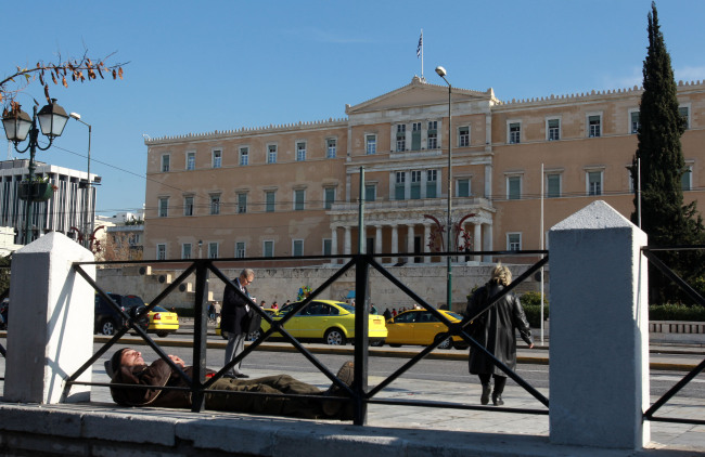 A man sleeps in the main Athens’ Syntagma square in front of the Greek parliament. ( Bloomberg)