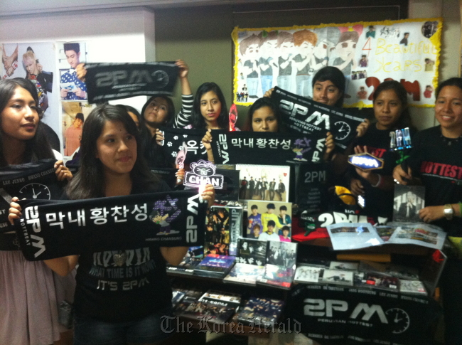 Peruvian fans of Korean band 2PM display signs, pictures and other products during a meeting in Lima. (Shin Hyon-hee/The Korea Herald)