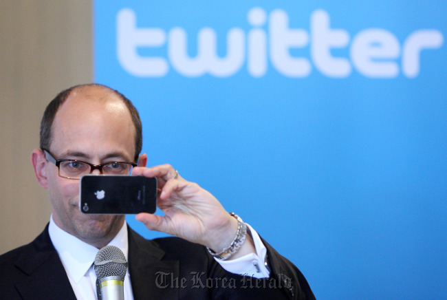 Dick Costolo, chief executive officer of Twitter Inc., takes a photograph using his Apple Inc. iPhone during a news conference in Tokyo on April 16, 2012. (Bloomberg)