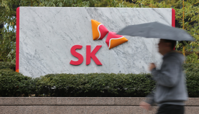 A pedestrian walks past the SK Group building in Seolin-dong, downtown Seoul. (Yonhap News)