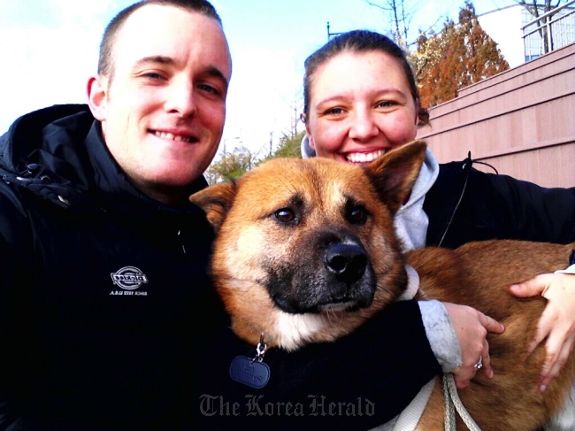 Matt and Danielle Curtis pose with their 4-year-old dog Pax, who was the inspiration for Brown Jindo Brewing.