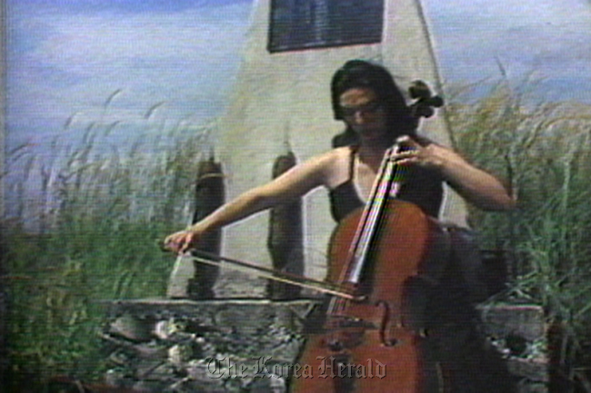 A scene from “Guadalcanal Requiem,” a video work by Nam June Paik with Charlotte Moorman. (Nam June Paik Art Center)