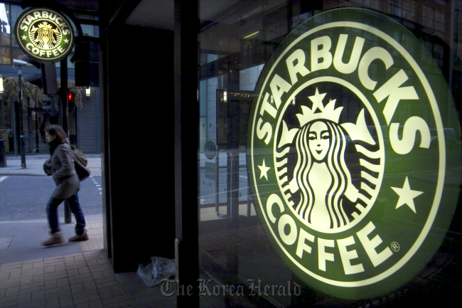 A pedestrian passes a Starbucks in central London. (Bloomberg)