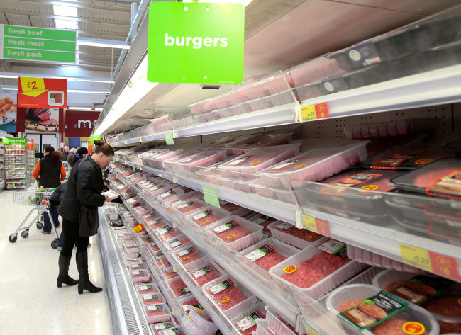 A customer picks up fresh meat at an Asda supermarket in London on Friday. (Xinhua-Yonhap News)