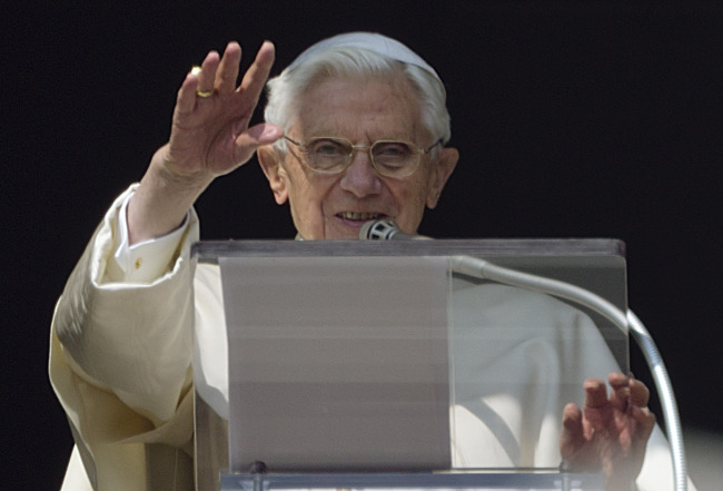 Pope Benedict XVI acknowledges a cheering crowd of faithfuls and pilgrims during his Angelus prayer from the window of his apartment at the Vatican on Sunday. (AP-Yonhap News)