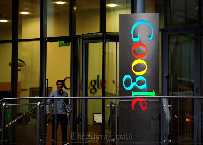 A pedestrian exits Gordon House, the current European headquarters of Google Inc. on Barrow Street in Dubin, Ireland. (Bloomberg)