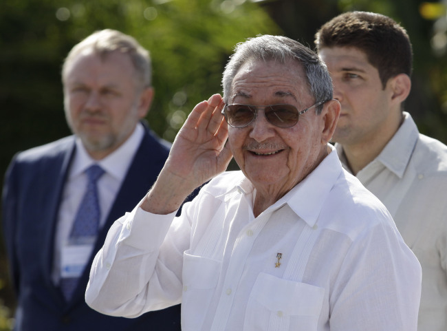 Cuba’s President Raul Castro (center) cups his hand to his ear to better hear a reporter’s question outside the Internationalist Soviet soldier mausoleum where he attended a tribute with the visiting Prime Minister of Russia Dmitry Medvedev in Havana on Friday. (AP-Yonhap News)