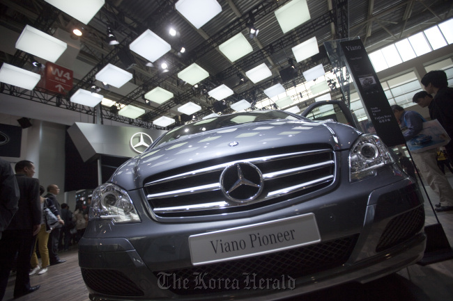 People examine Daimler AG Mercedes-Benz vehicles at the company’s stand during the auto show in Beijing. (Bloomberg)