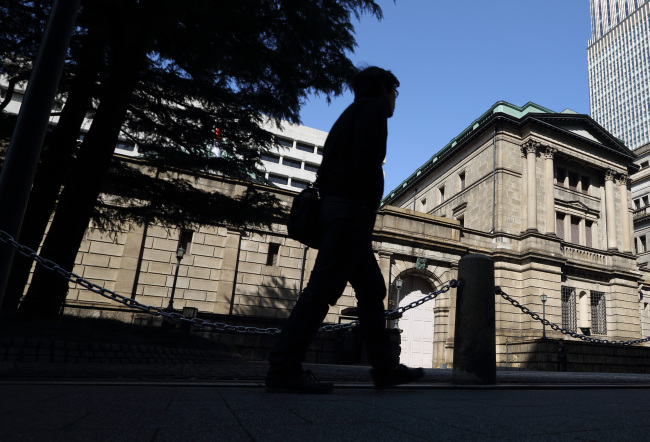 A man walks past the Bank of Japan headquarters in Tokyo. (Bloomberg)