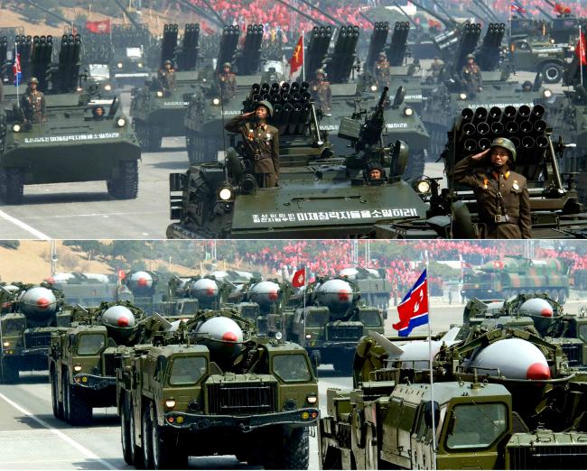 A photo carried by North Korea’s Rodong Shinmun on Wednesday shows a parade of armed vehicles loaded with multiple rocket launchers in Pyongyang.(Yonhap News)