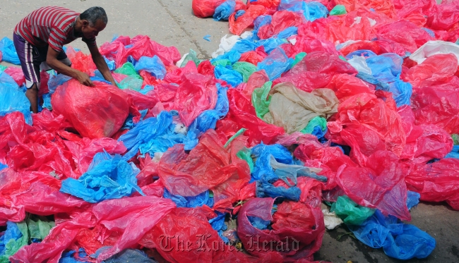 A man collects used plastic bags for recycling in Kathmandu, Nepal. (The Kathmandu Post)