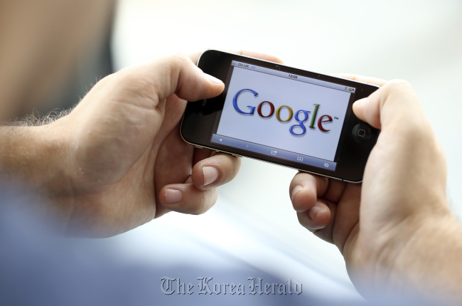 The Google Inc. logo is seen on an Apple Inc. iPhone 4 in London. (Bloomberg)