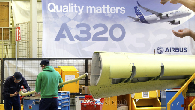 Employees work on the Airbus A320 single-aisle passenger aircraft wing production line at the company’s factory in Broughton, England. (Bloomberg)