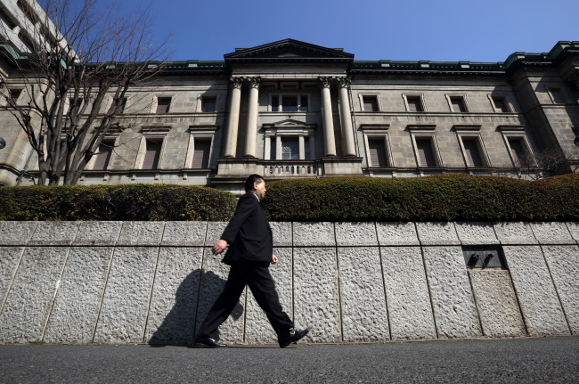 A man walks past the Bank of Japan headquarters in Tokyo. (Bloomberg)