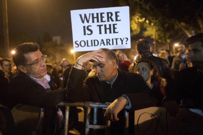 Demonstrators protest outside the parliament in Nicosia, Cyprus, Thursday. (Bloomberg)