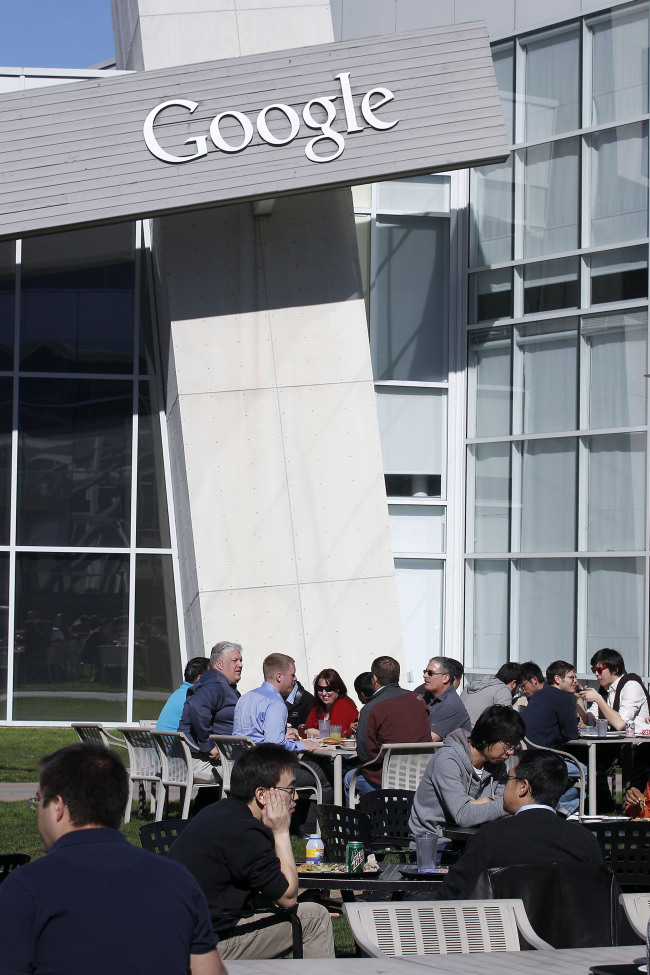 Google Inc. employees sit outside during lunch at the company’s headquarters in Mountain View, California. (Bloomberg)