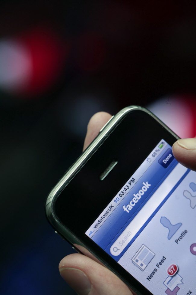 The Facebook Inc. logo is seen on an Apple Inc. iPhone in London. (Bloomberg)