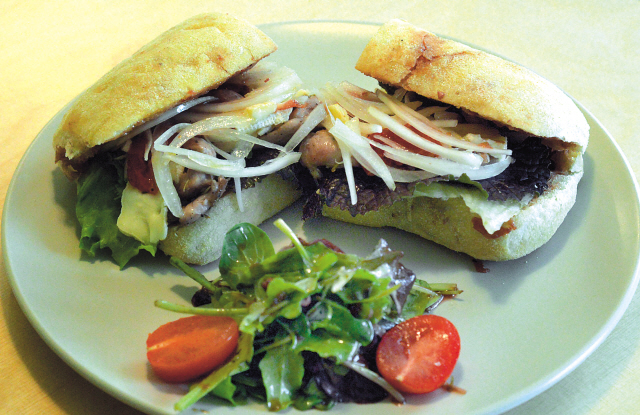 The chicken sandwich takes airy housemade ciabatta and fills it with succulent rosemary-red wine chicken breast, creamy brie cheese, sundried tomatoes and crisp greens. (Chung Hee-cho/The Korea Herald)