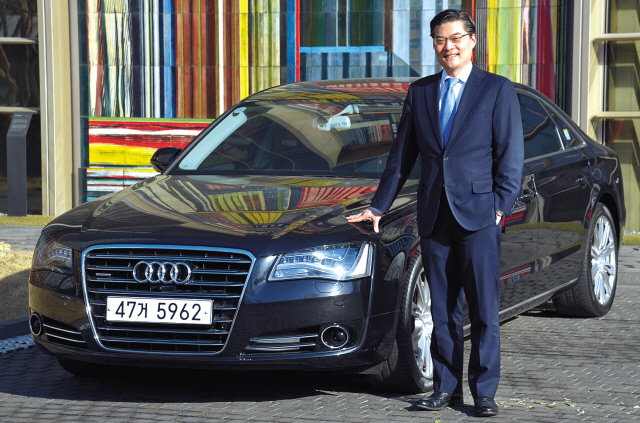 Paul J. Kim, corporate partner at international law firm McDermott Will & Emery, poses with the Audi A8L TDI Quattro. (Kim Myung-sub/The Korea Herald)