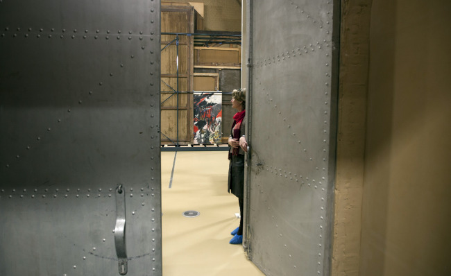 Press and communications officer Veronique Van Passel opens giant steel doors which lead to an interior warehouse in the Antwerp Royal Museum of Fine Arts in Antwerp, Belgium, Thursday. (AP-Yonhap News)