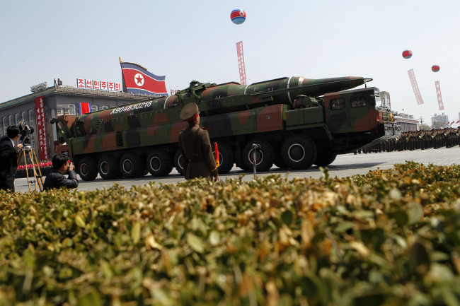 A North Korean vehicle carrying what appears to be a new missile passes by during a mass military parade in Pyongyang’s Kim Il-sung Square to celebrate the centenary of the birth of the late North Korean founder Kim Il-sung on April 15, 2012. (AP-Yonhap News)