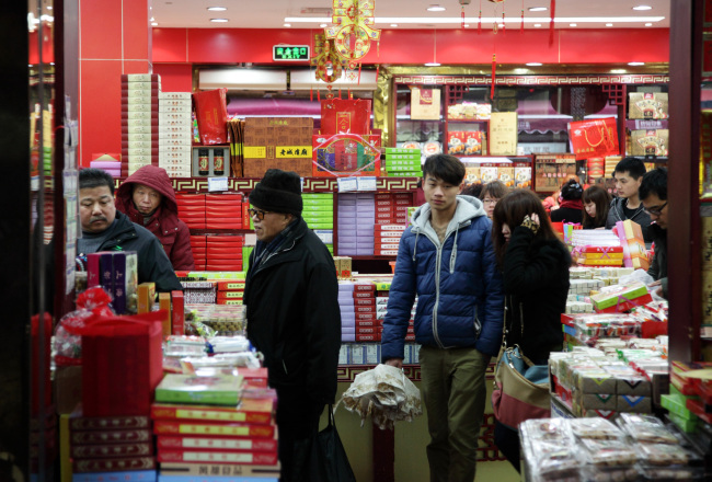 Customers shop at a store selling snacks in Shanghai. ( Bloomberg)