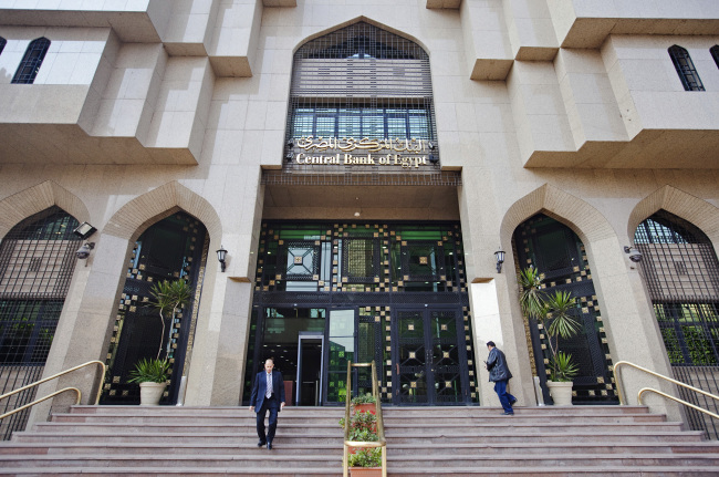 Pedestrians use the stairs outside of Egypt’s central bank in Cairo. (Bloomberg)