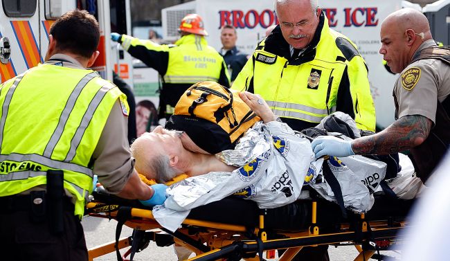 A man is loaded into an ambulance after he was injured by one of two bombs exploded during the 117th Boston Marathon near Copley Square on April 15, 2013 in Boston, Massachusetts.(AFP)