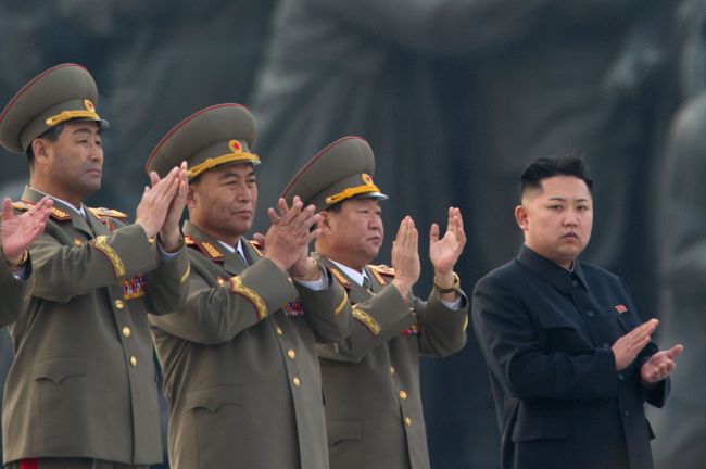 North Korean leader Kim Jong-un (right) claps during the unveiling ceremony of two statues of former leaders Kim Il-sung and Kim Jong-il in Pyongyang. (AFP)