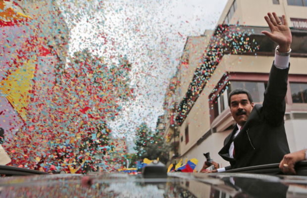 Venezuelan President Nicolas Maduro waves to supporters as he arrives to the National Assembly for his swearing-in ceremony in Caracas, Venezuela, Friday. (AP-Yonhap News)