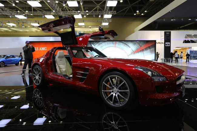 An attendee takes a photograph of the Daimler AG Mercedes-Benz SLS AMG vehicle on display during the Seoul Motor Show in Goyang on March 28. (Bloomberg)